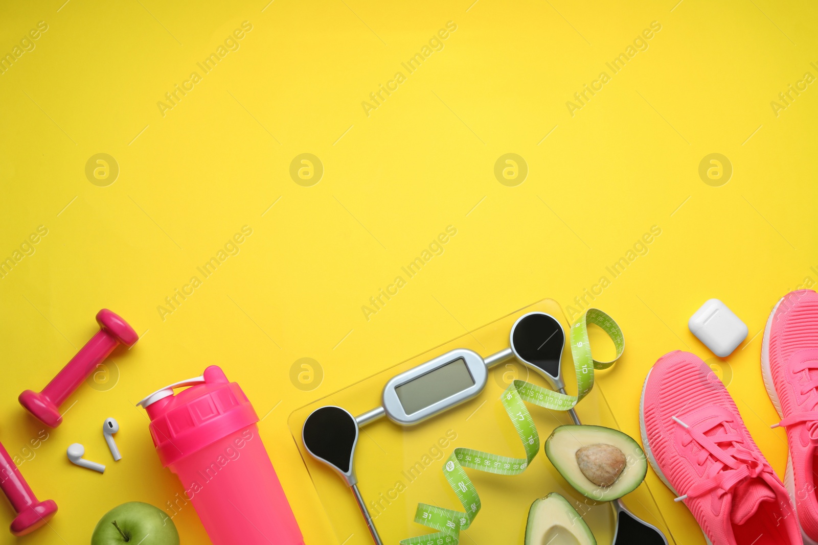 Photo of Flat lay composition with electronic scales and measuring tape on yellow background, space for text