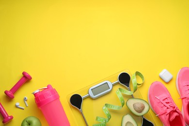 Flat lay composition with electronic scales and measuring tape on yellow background, space for text