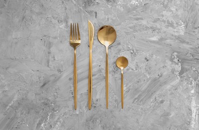 Photo of Beautiful cutlery set on grey table, flat lay