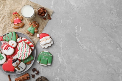 Flat lay composition with delicious homemade Christmas cookies on grey marble table. Space for text