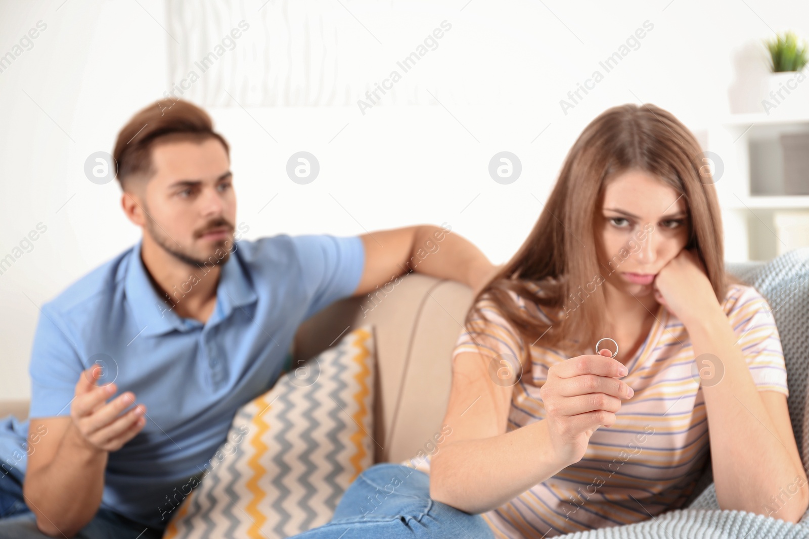 Photo of Young couple with relationship problems in living room