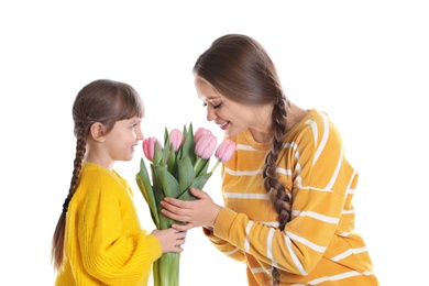 Happy mother and daughter with flower bouquet on white background. International Women's Day