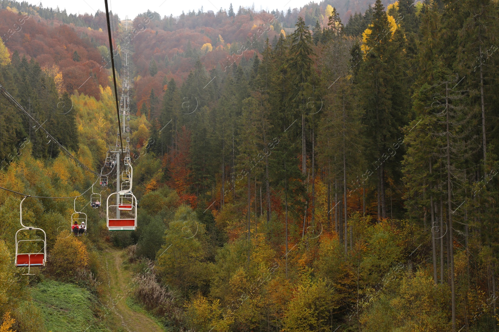 Photo of Chairlift with comfortable seats at mountain resort