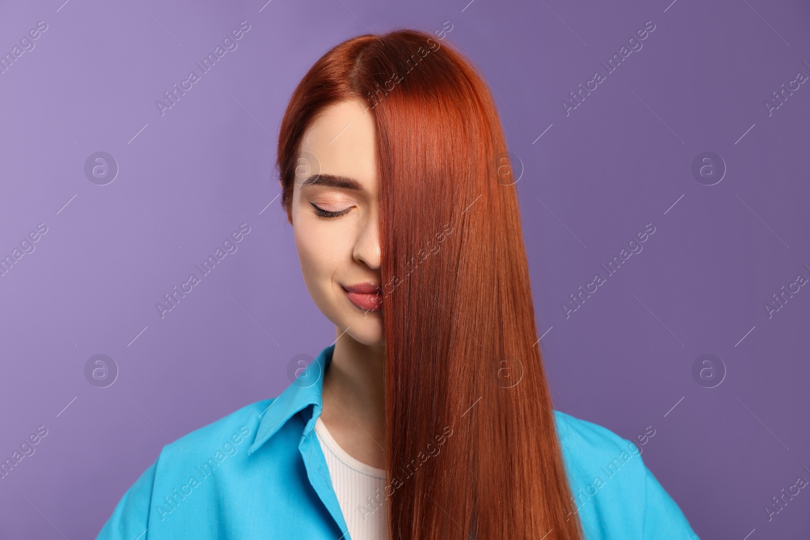 Photo of Beautiful woman with red dyed hair on purple background