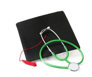 Photo of Stethoscope and graduation hat on white background. Medical students stuff