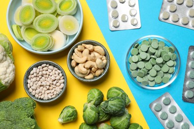 Many prebiotic pills and food on color background , flat lay