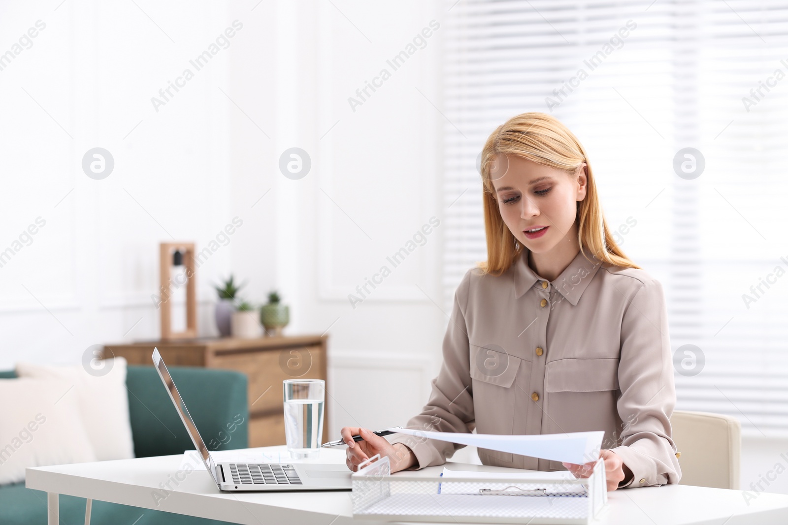 Photo of Professional lawyer working on laptop at table in office