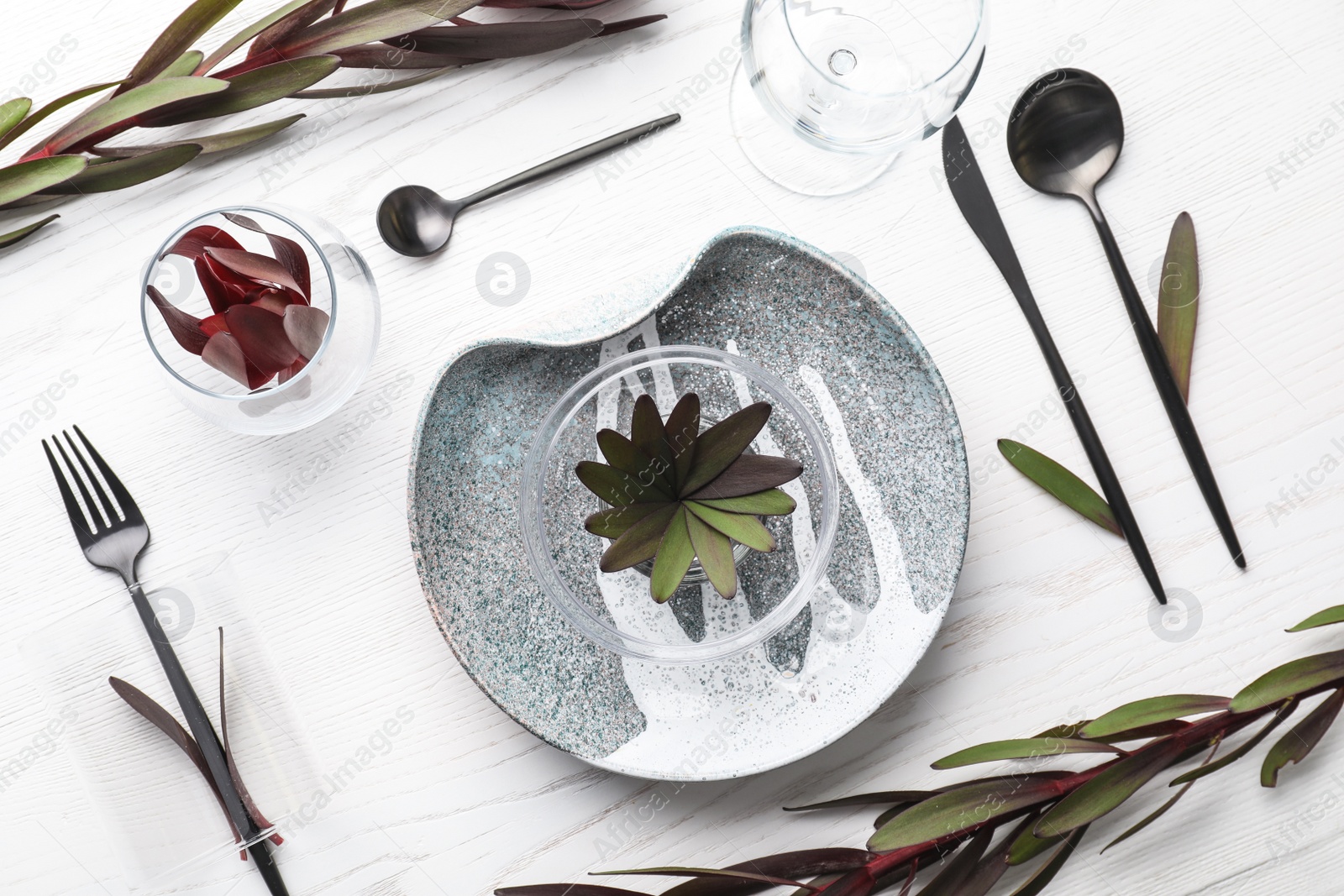 Photo of Elegant table setting with floral decor on white wooden background, flat lay