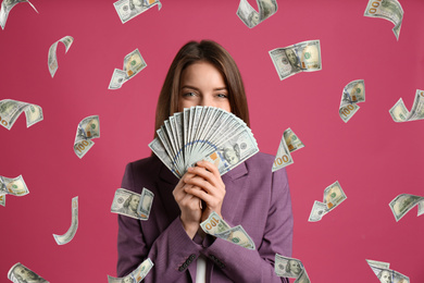 Image of Woman with American dollars under money rain on color background