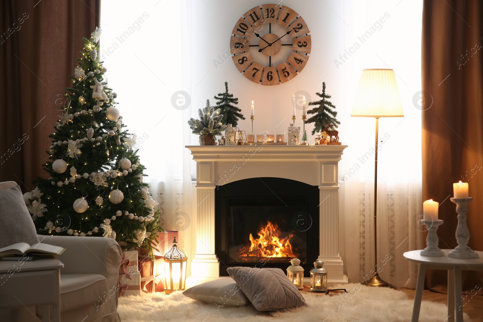 Photo of Beautiful room interior with small firs, fireplace and decorated Christmas tree