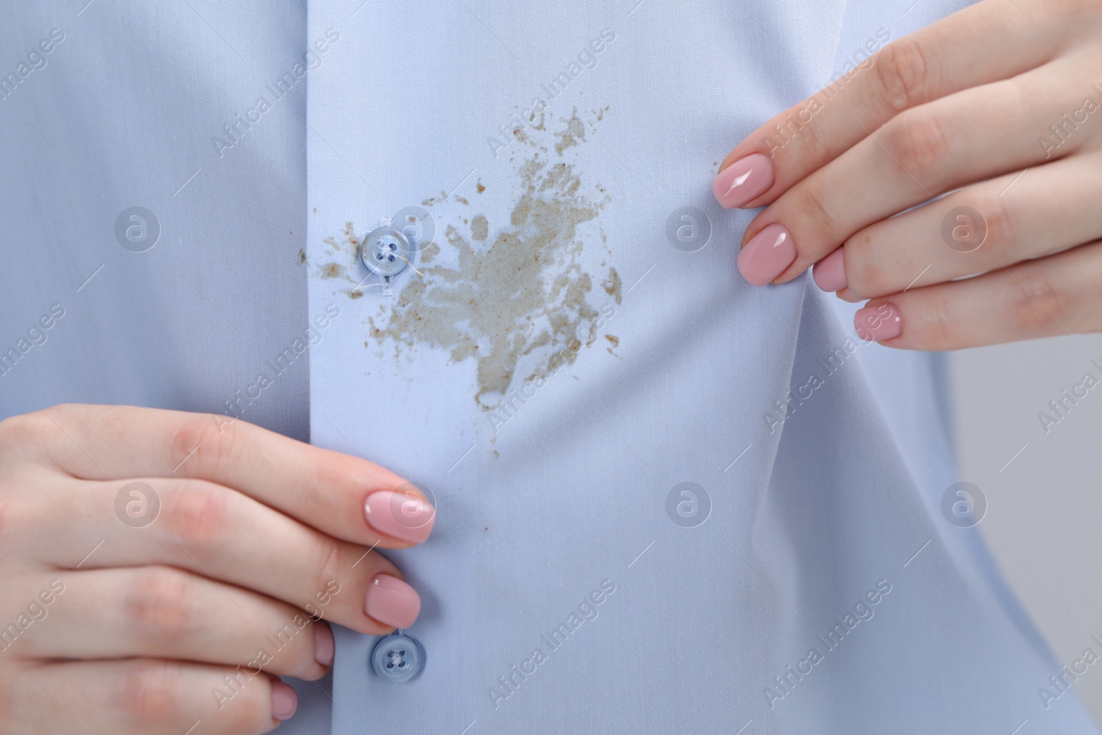 Photo of Woman showing stain on her shirt, closeup