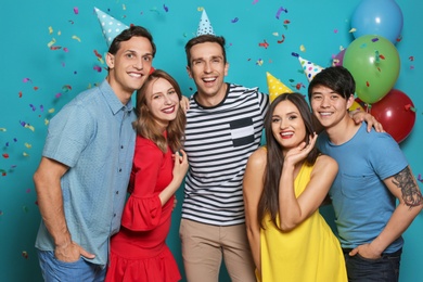 Happy young people celebrating birthday together on color background