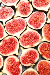 Photo of Cut ripe figs as background, top view