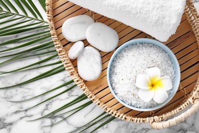 Photo of Flat lay composition with white sea salt on marble background. Spa treatment