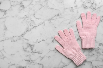 Photo of Stylish pink gloves on white marble background, flat lay. Space for text
