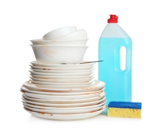 Photo of Pile of dirty kitchenware, dish detergent and sponge on white table