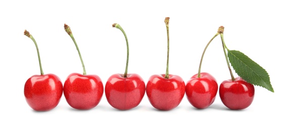 Photo of Row of ripe sweet cherries on white background