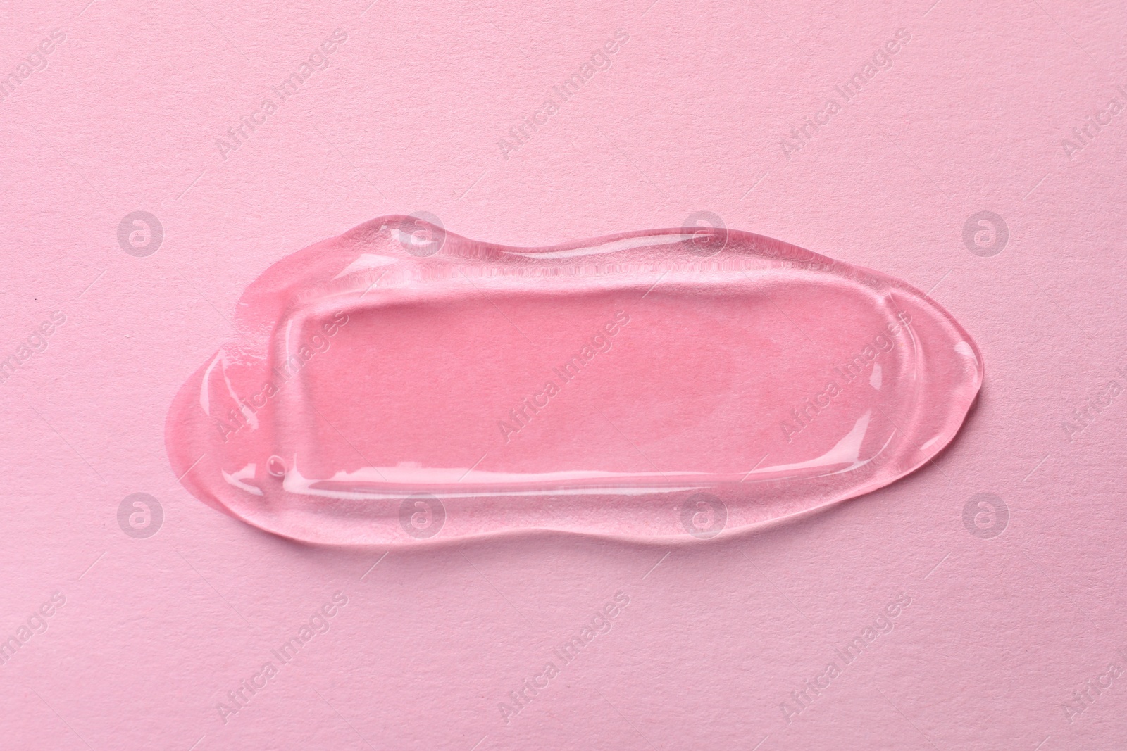 Photo of Swatch of cosmetic gel on pink background, top view