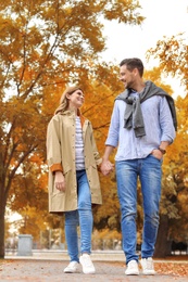 Photo of Lovely couple spending time together in park. Autumn walk