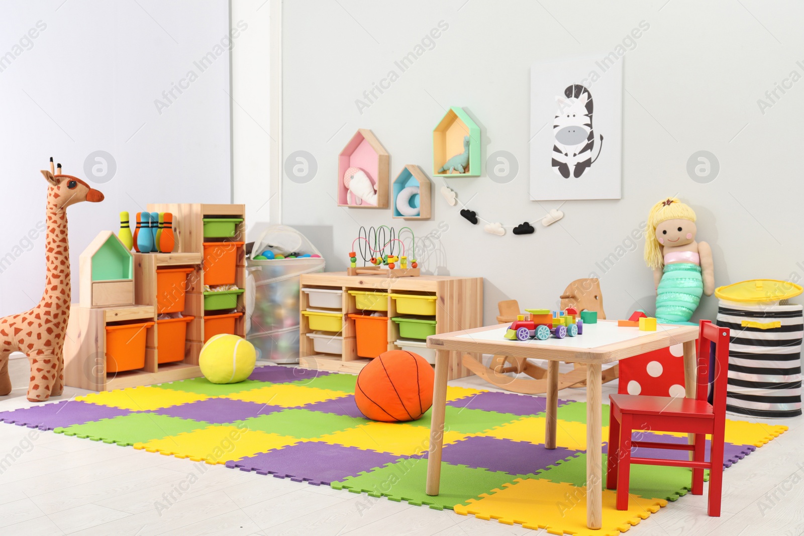 Photo of Cute child's room interior with toys and modern furniture