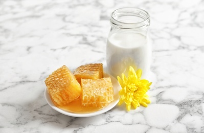 Photo of Beautiful composition with milk and honey on light background