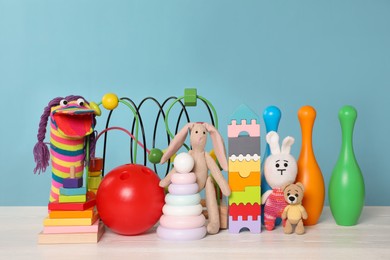 Collection of different toys on white wooden table