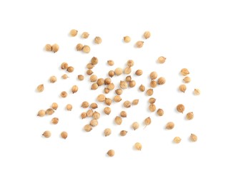 Scattered dried coriander seeds on white background, top view