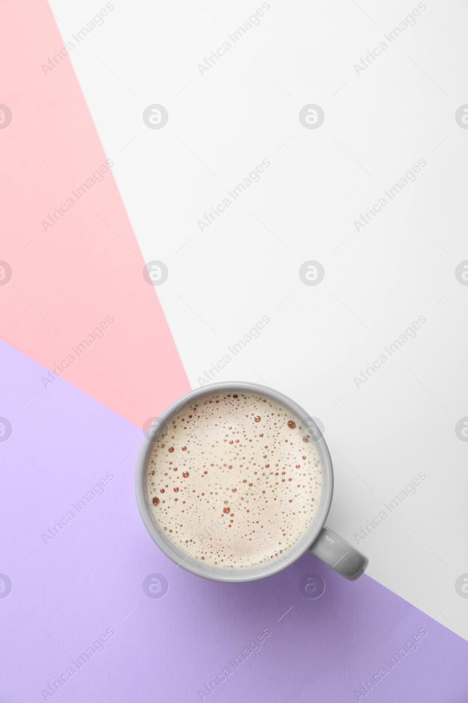 Photo of Cup of coffee on color background, top view. Space for text