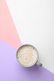 Photo of Cup of coffee on color background, top view. Space for text