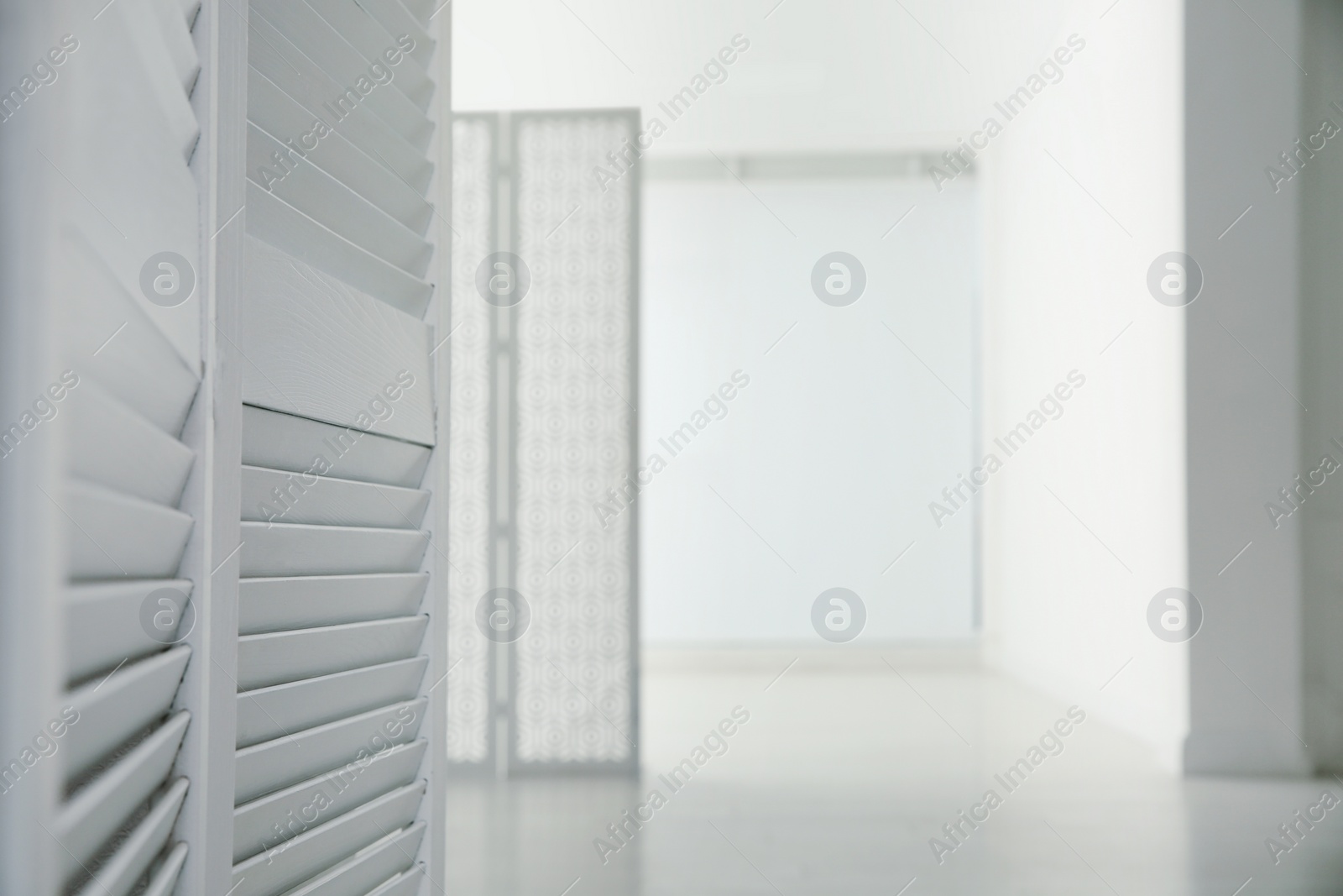 Photo of Empty office corridor with white walls and wooden floor