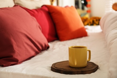 Hot drink on bed with pillows at home