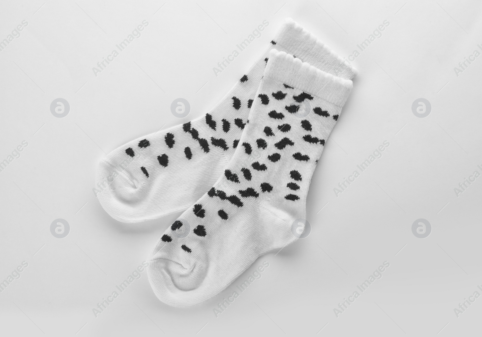 Photo of Cute child socks on white background, top view