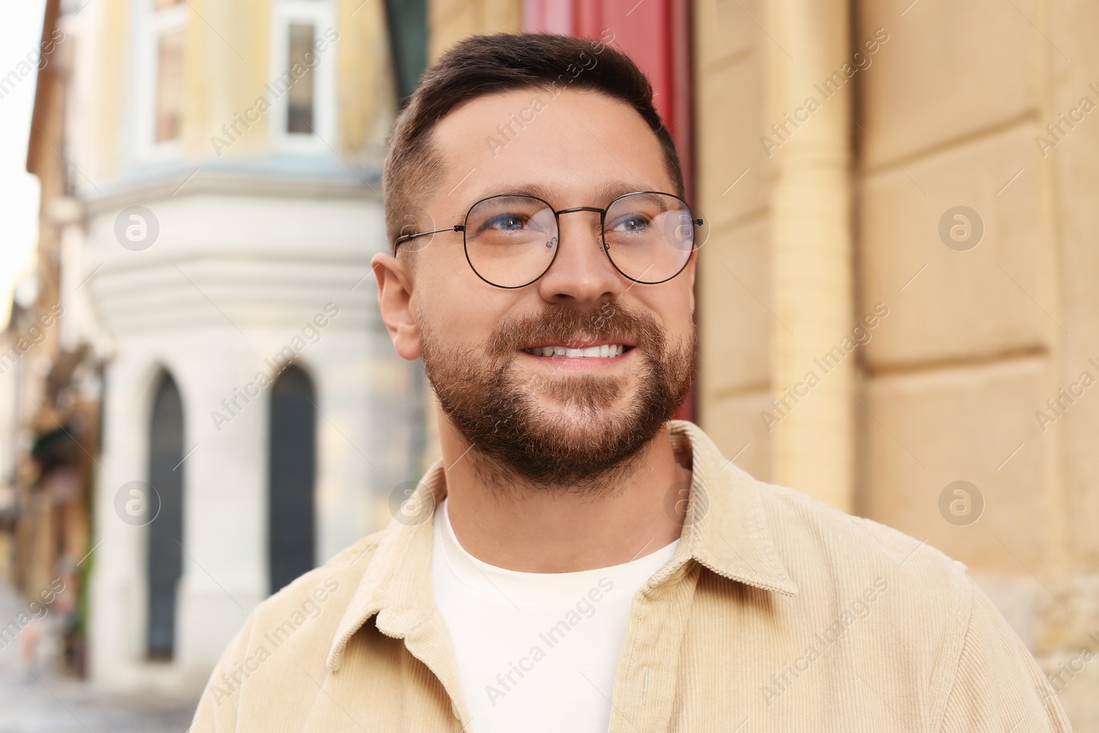 Photo of Portrait of handsome bearded man in glasses outdoors