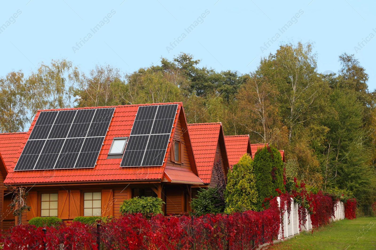 Photo of Beautiful houses with solar panels outdoors. Real estate for rent