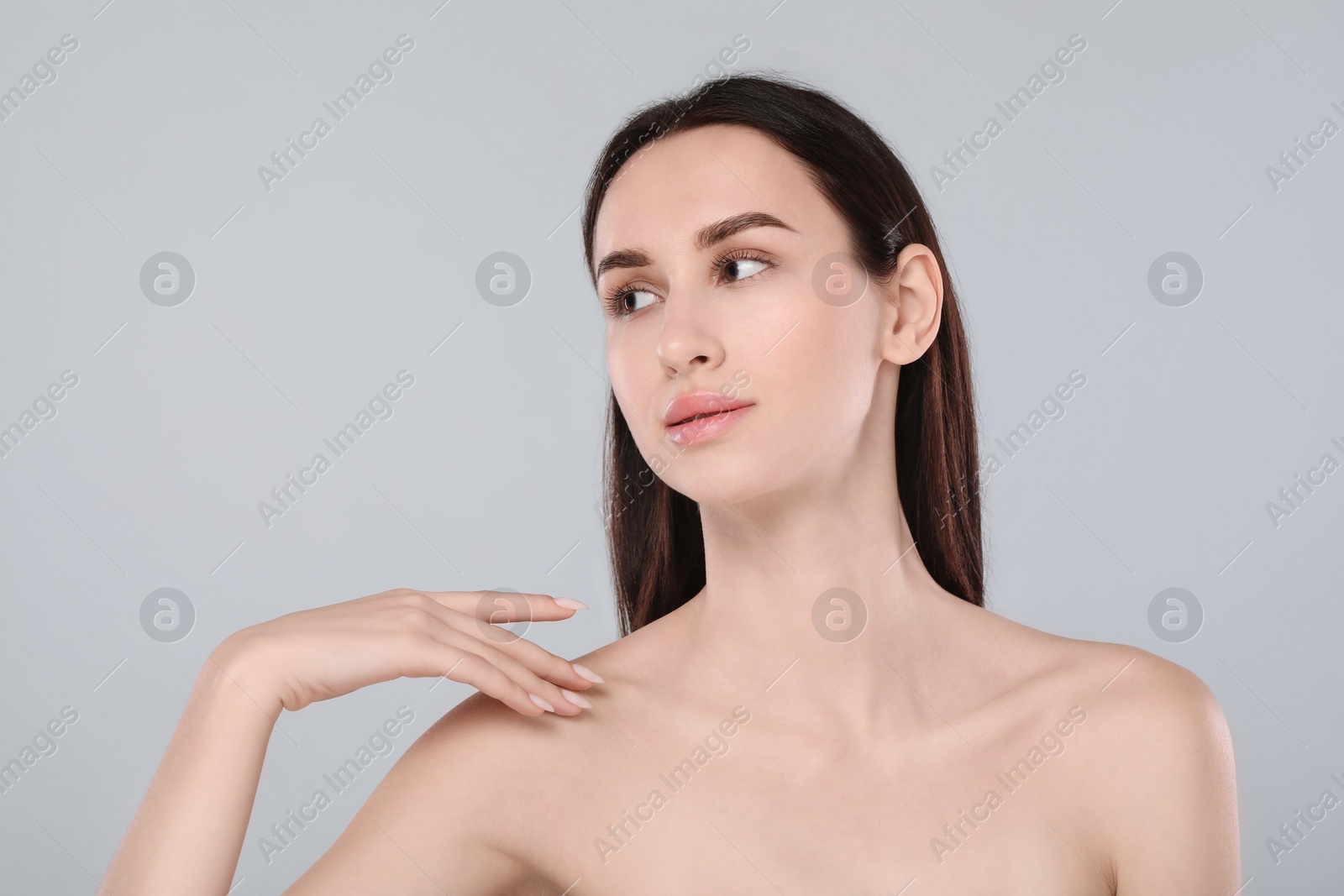 Photo of Portrait of beautiful young woman on light grey background