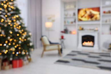 Photo of Blurred view of beautiful Christmas tree with festive lights in living room