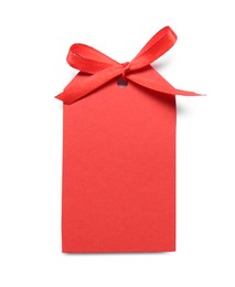 Photo of Blank red gift tag with satin ribbon on white background, top view