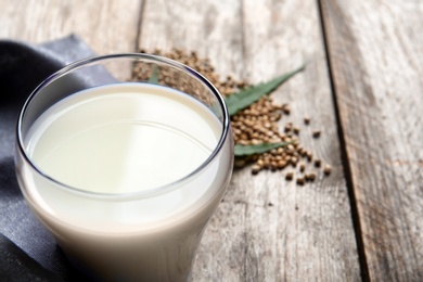 Photo of Glass of hemp milk on table, closeup