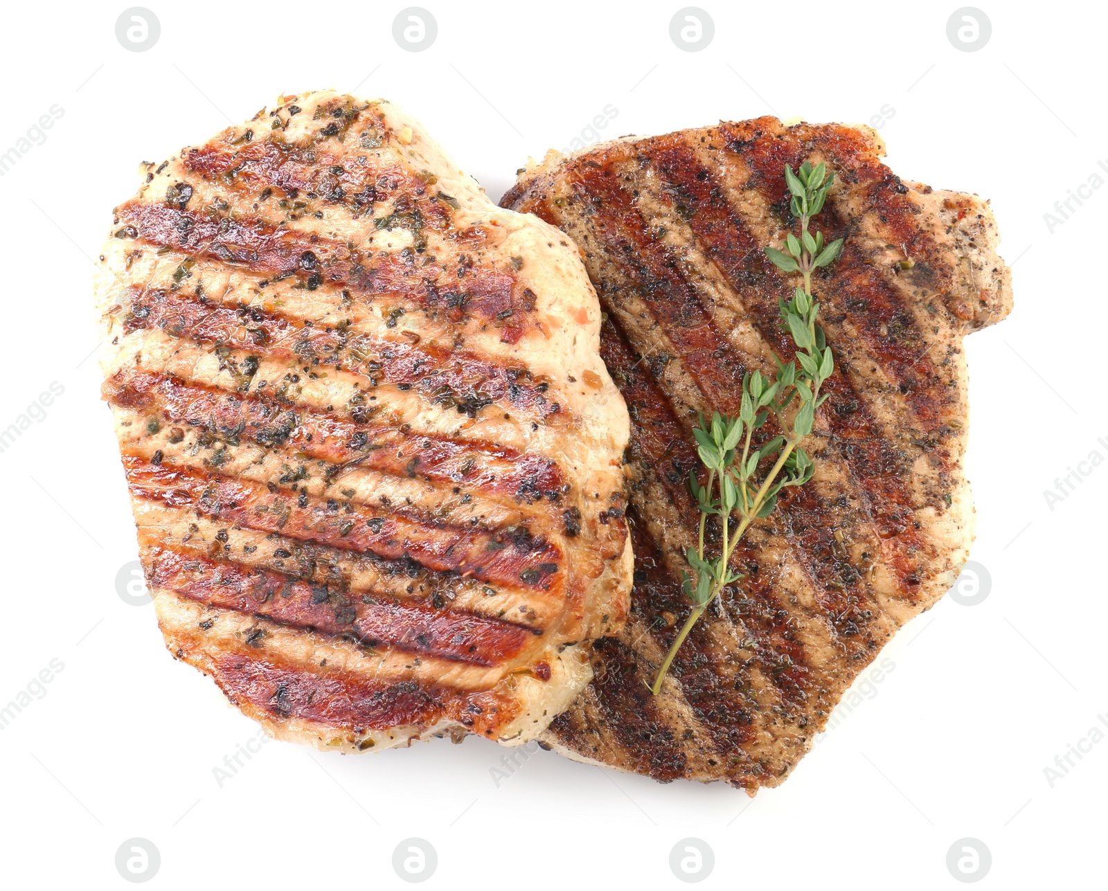 Photo of Delicious grilled pork steaks and thyme on white background, top view