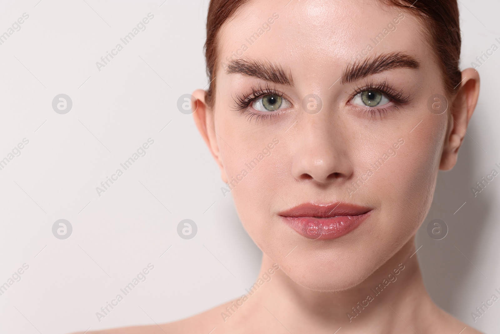 Photo of Portrait of beautiful woman on light background, closeup. Space for text