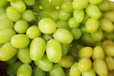 Fresh ripe juicy white grapes as background, closeup view