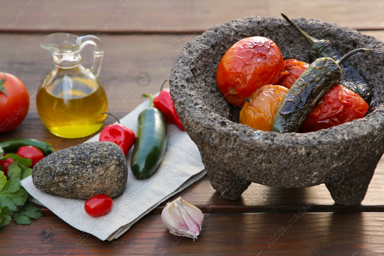 Photo of Ingredients for tasty salsa sauce, pestle and mortar on wooden table