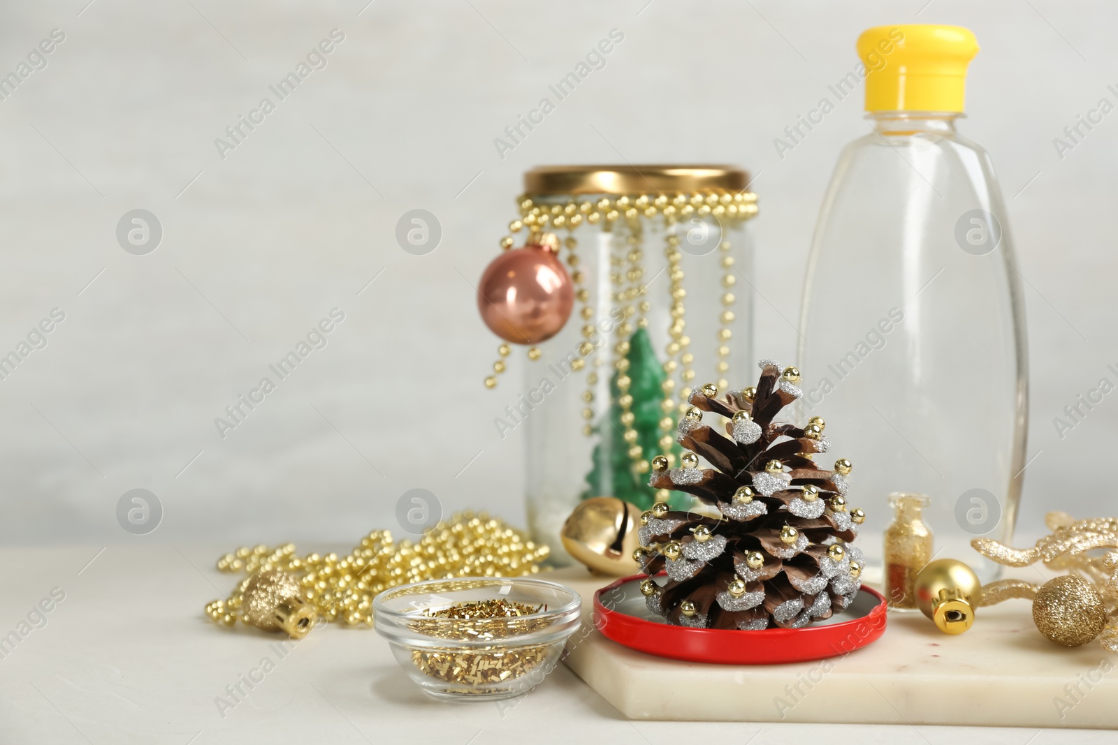 Photo of Materials for handmade snow globe on light table, space for text