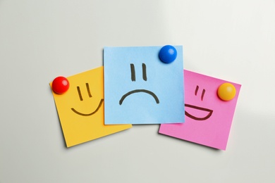Photo of Stickers with sad and happy faces on white background, flat lay