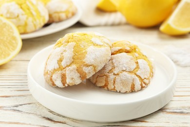 Tasty homemade lemon cookies on white wooden table