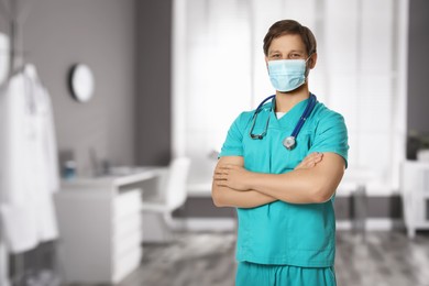 Nurse with stethoscope and medical mask in uniform at hospital