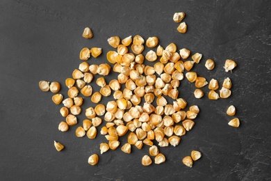 Photo of Raw dry corn seeds on grey background, flat lay. Vegetable planting
