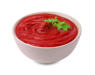 Organic ketchup and parsley in bowl isolated on white. Tomato sauce