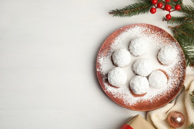 Photo of Flat lay composition with tasty Christmas snowball cookies on white table. Space for text