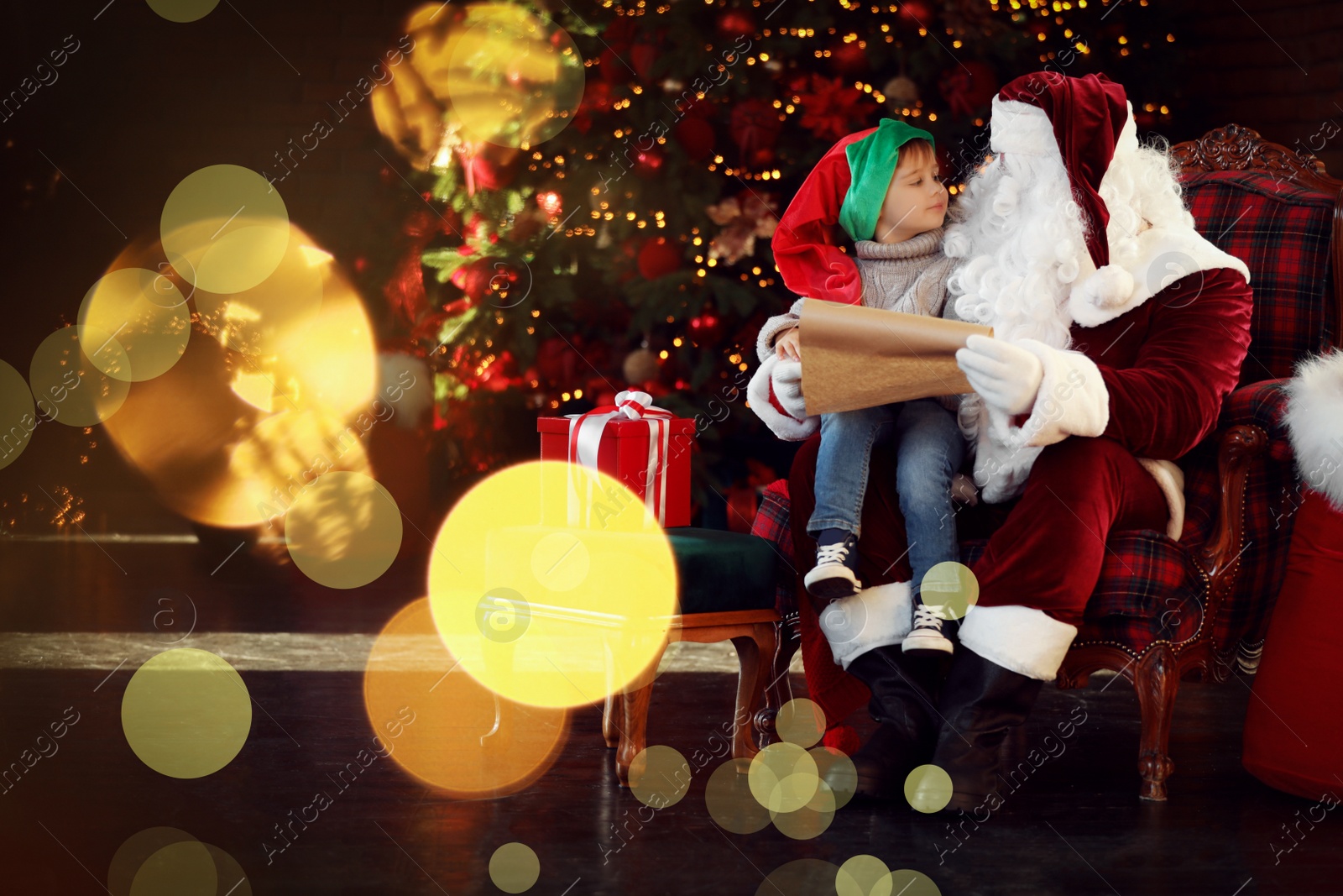 Photo of Santa Claus and little boy near Christmas tree indoors